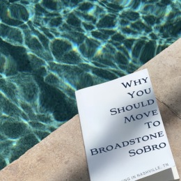 a book beside the pool